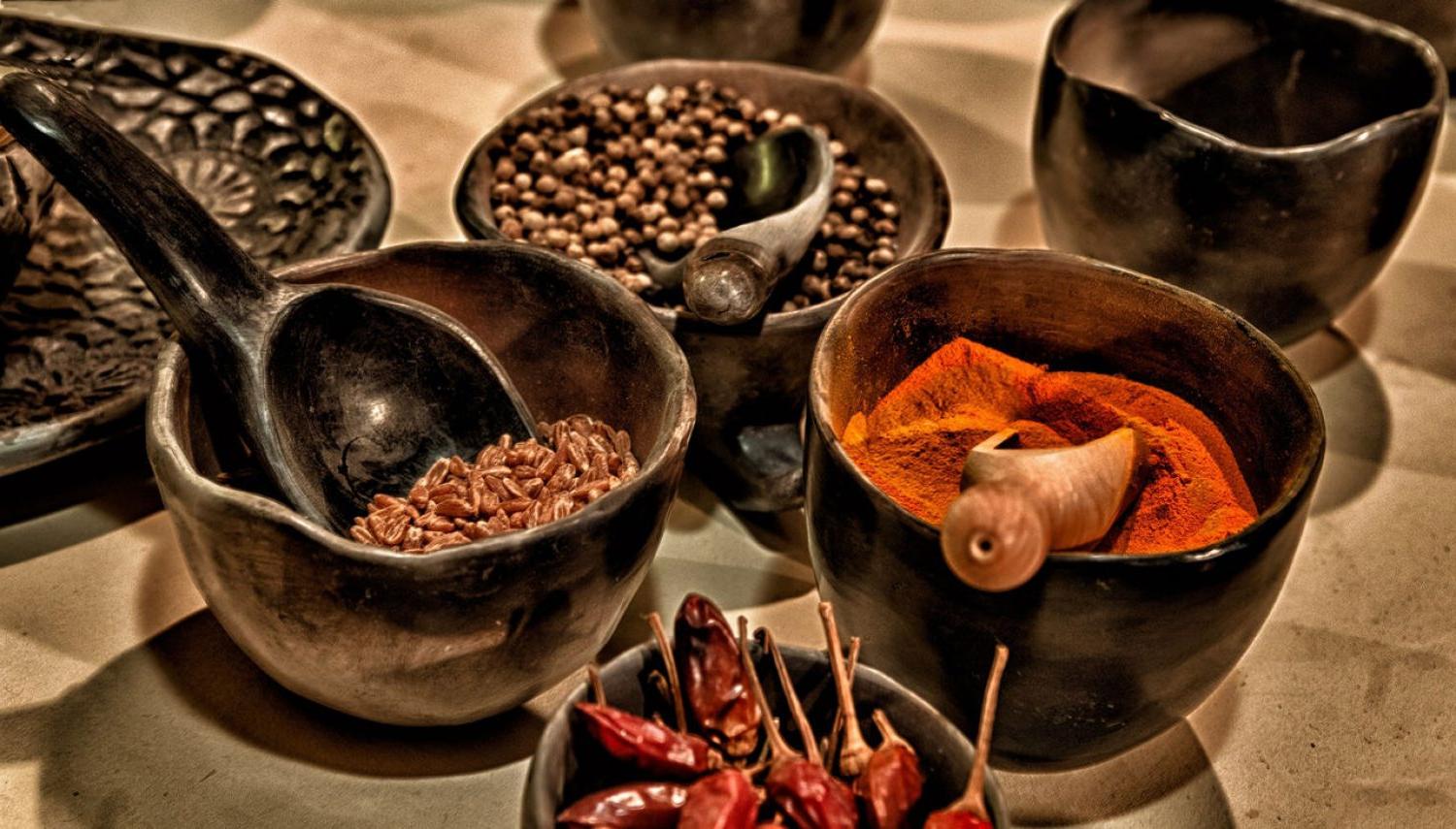 an array of spices in bowls